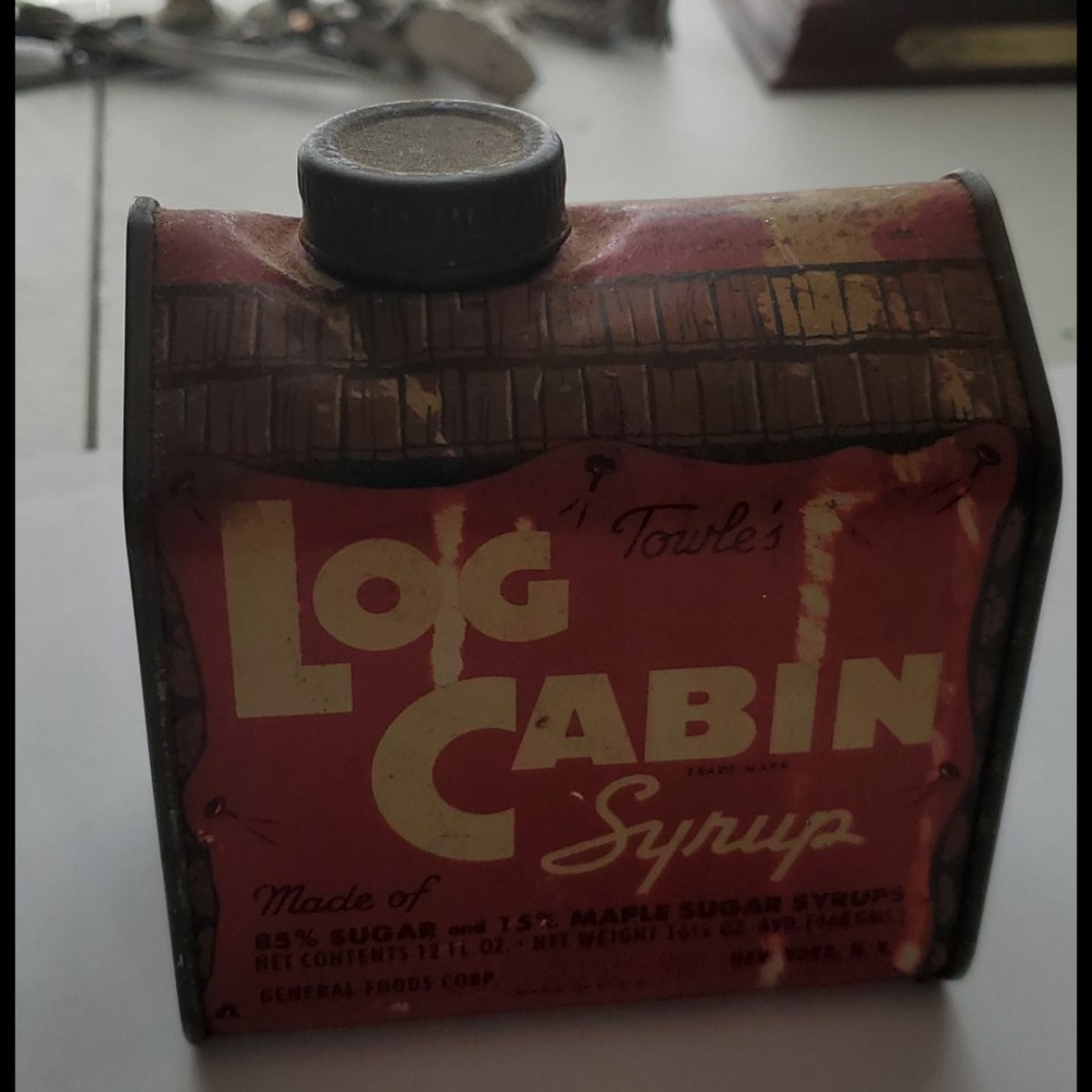 Vintage log cabin syrup tin